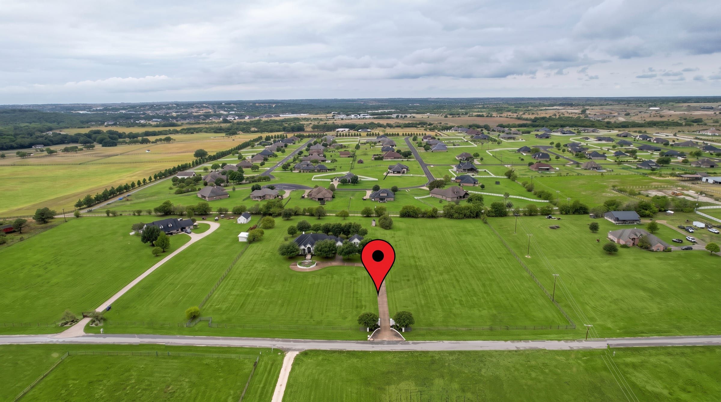 Aerial view from the road with a pin marking the home