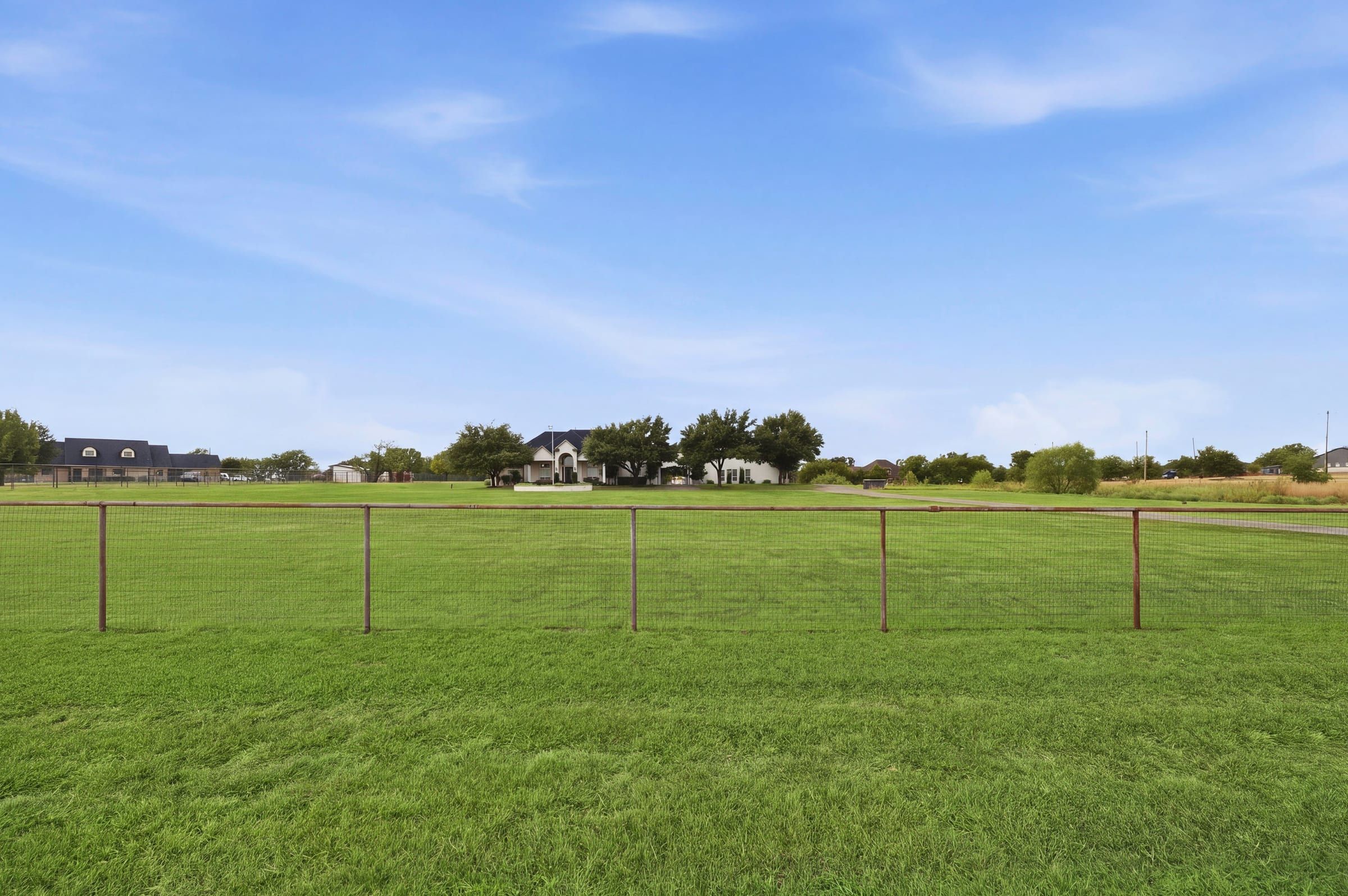 Fenced pasture looking toward the home