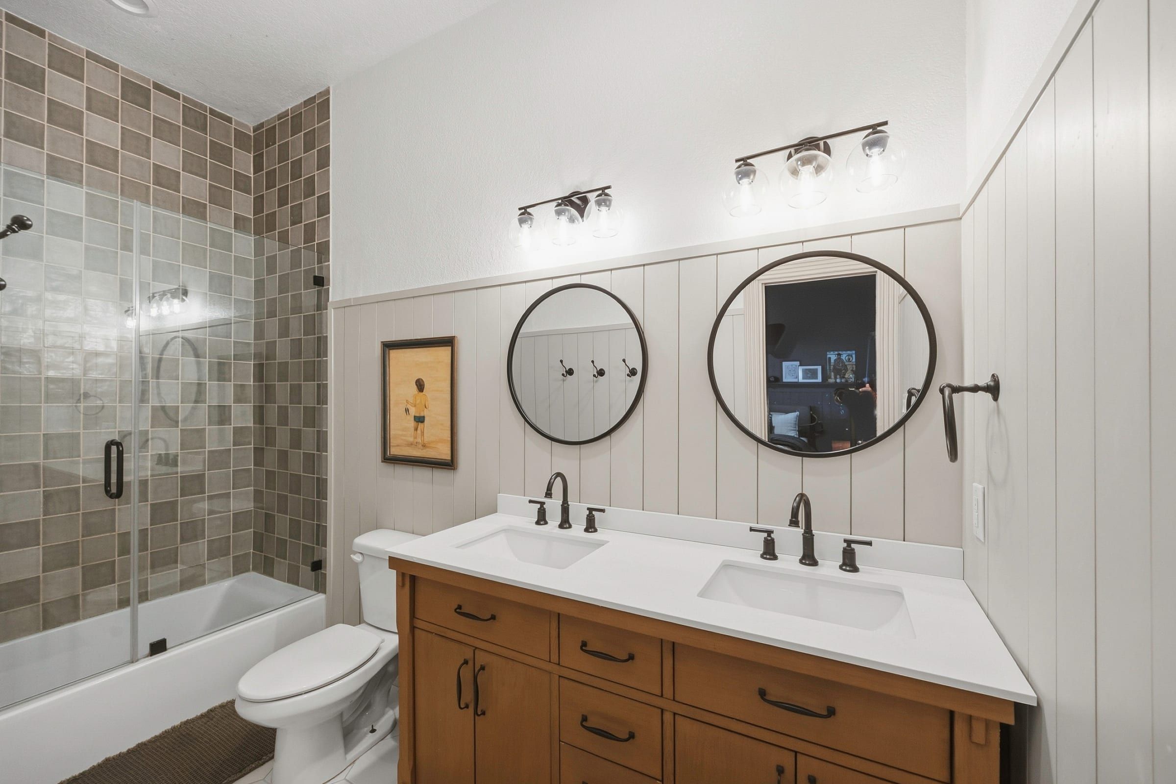 Updated full bath with tub and shower and a double vanity