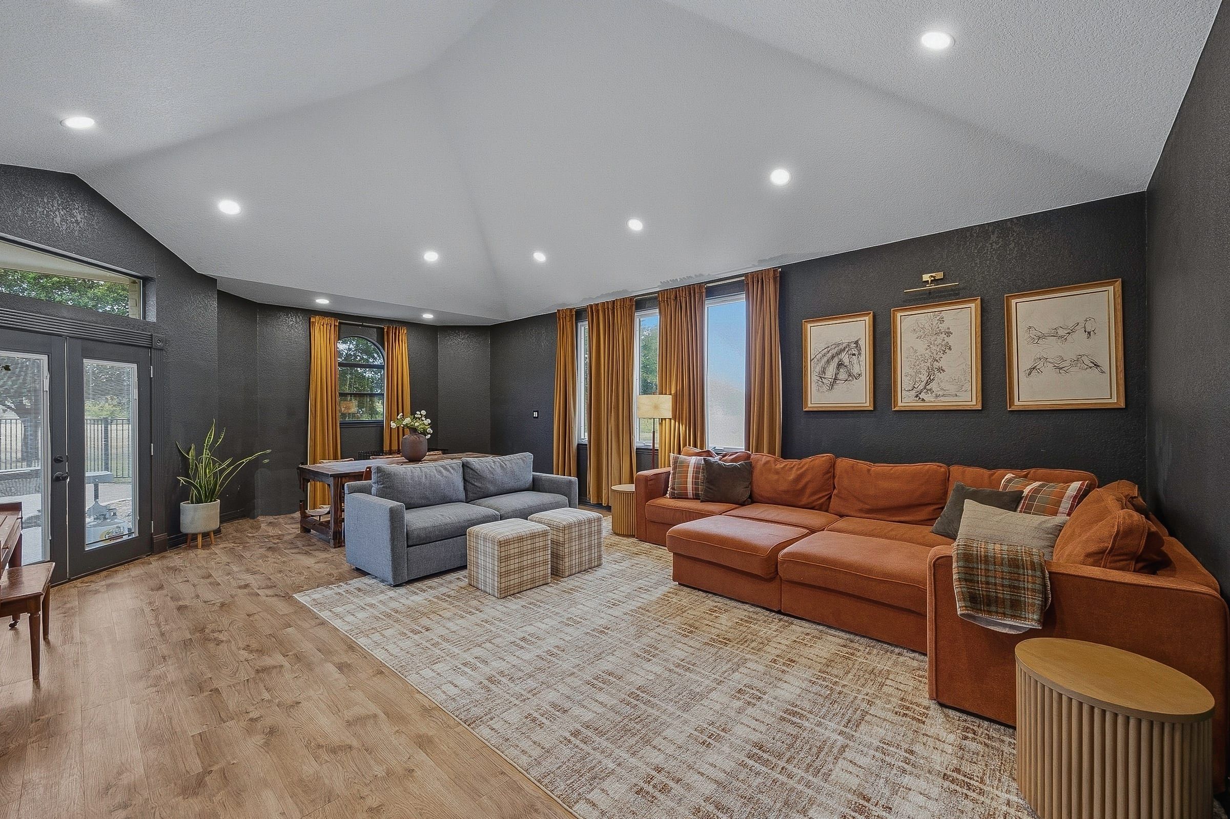 Game room with vaulted ceiling and French doors to the pool deck