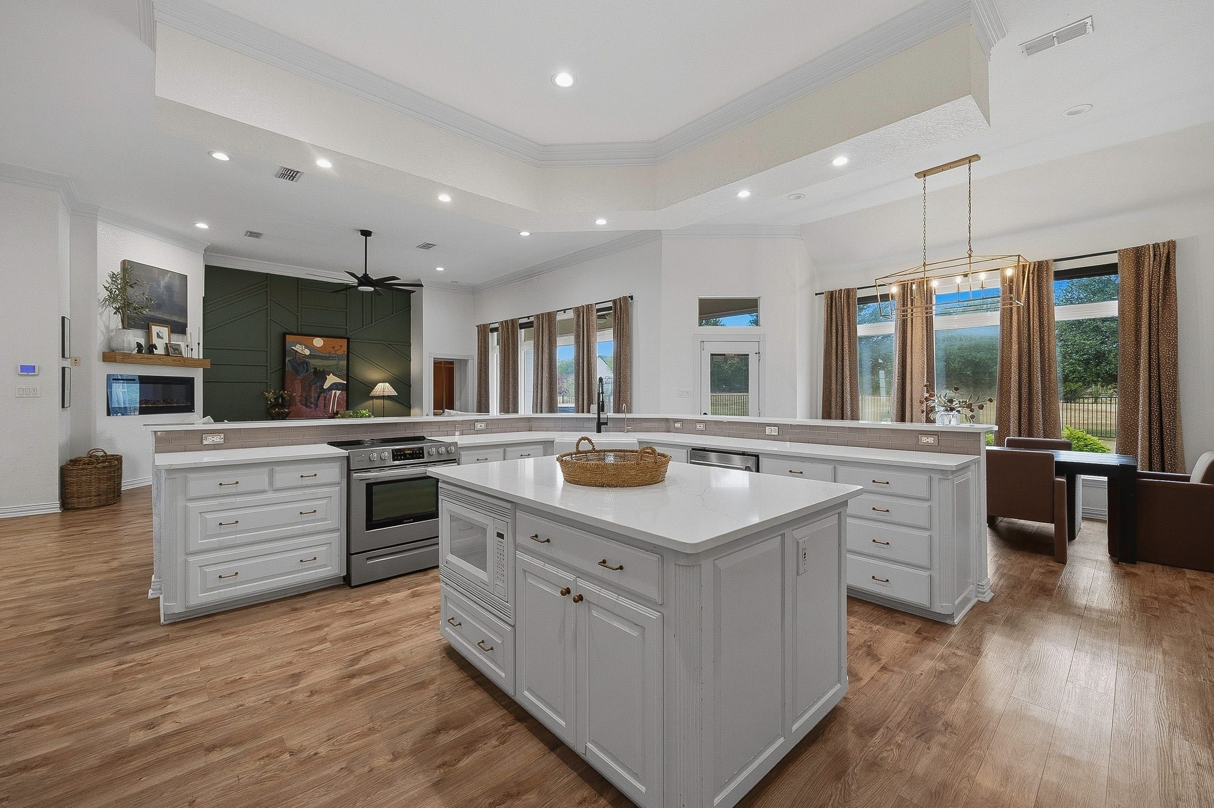 Kitchen island with stainless range and breakfast area