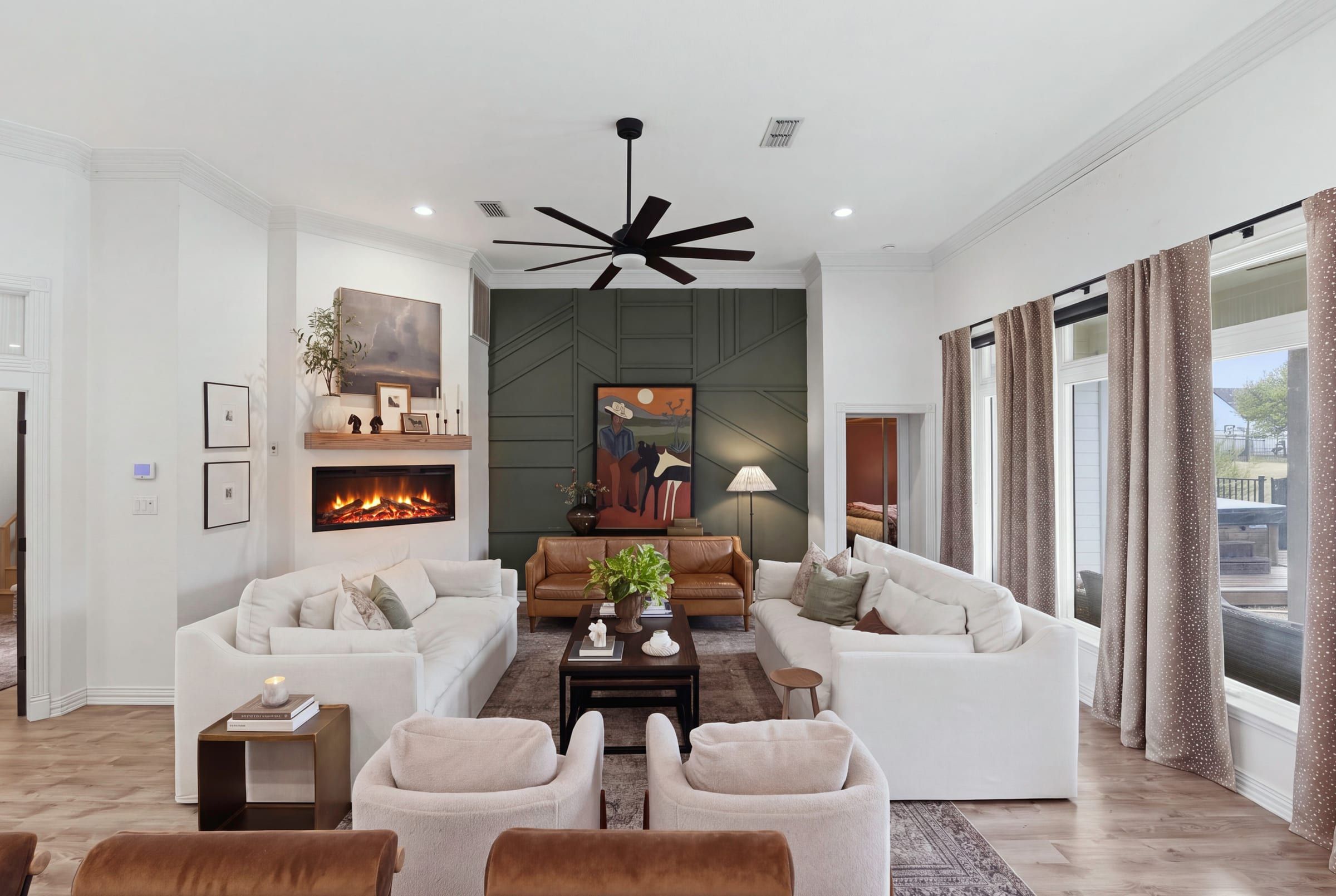 Living room with linear fireplace and paneled accent wall