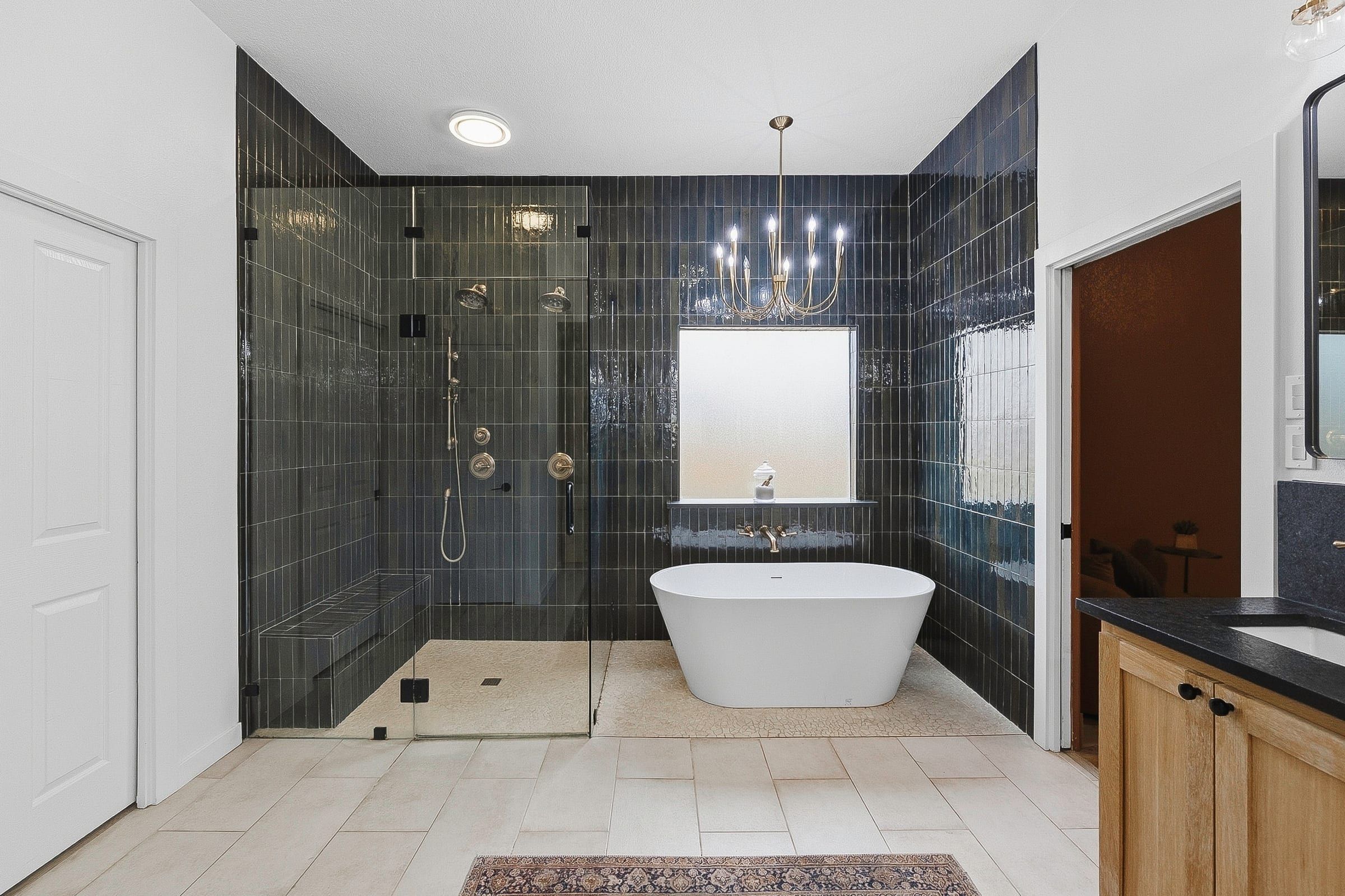 Master bath remodeled in 2024 with a glass shower and freestanding tub